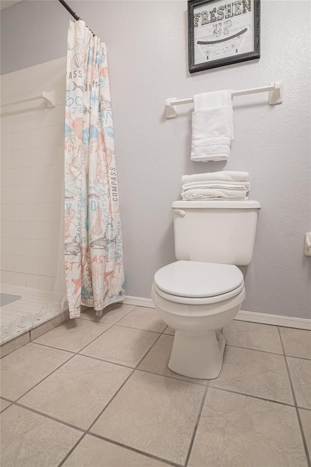 bathroom with walk in shower, tile patterned floors, and toilet