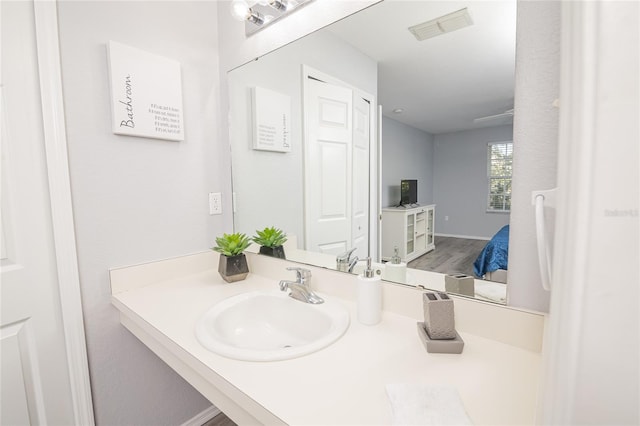 bathroom with vanity and hardwood / wood-style flooring