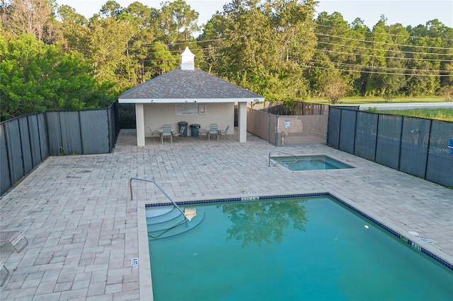 view of swimming pool with a patio and a gazebo