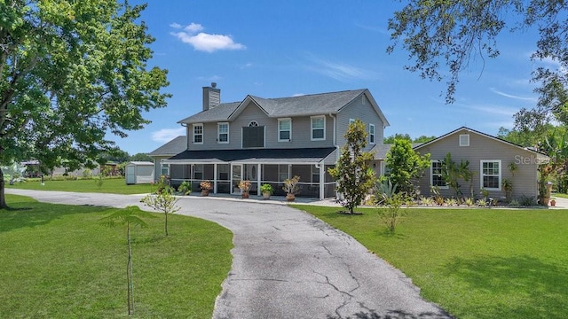 view of front of home with a front yard and a garage