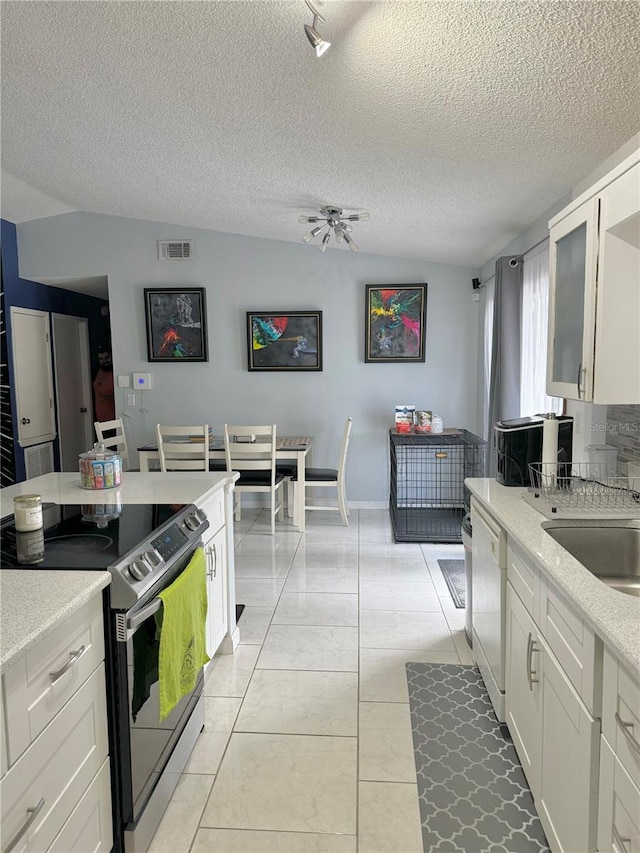 kitchen featuring white cabinets, dishwasher, stainless steel electric range oven, and a textured ceiling