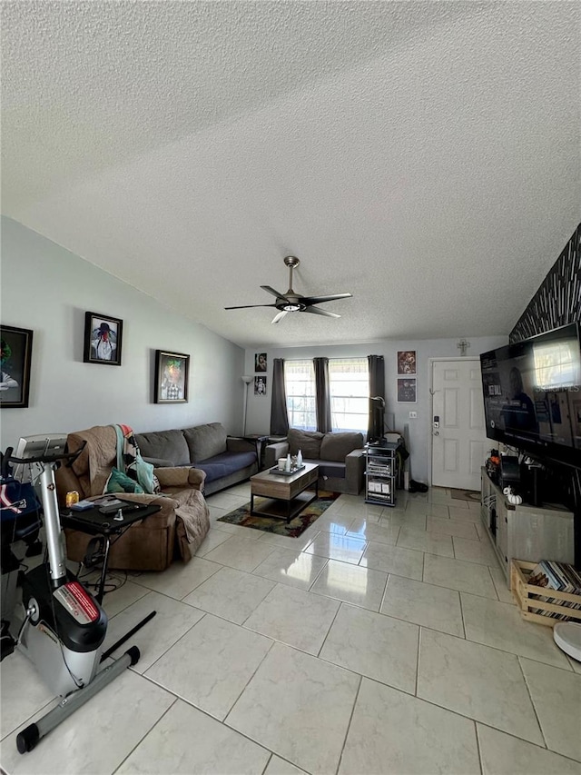 tiled living room with ceiling fan, a textured ceiling, and lofted ceiling