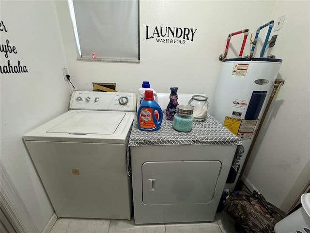 washroom with washer and clothes dryer and electric water heater