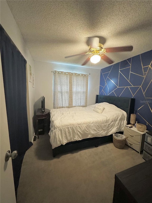 carpeted bedroom with ceiling fan and a textured ceiling