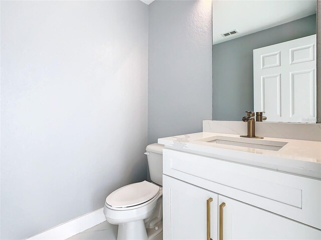 bathroom featuring vanity, toilet, and tile patterned flooring