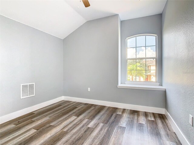 additional living space with hardwood / wood-style flooring, ceiling fan, and vaulted ceiling