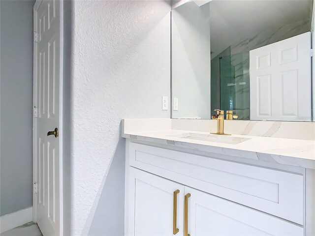 bathroom with vanity and walk in shower