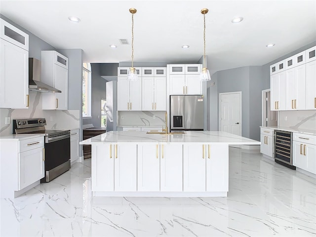 133 Andalusia Loop, Davenport, FL 33837 - kitchen featuring stainless steel appliances, wine cooler, visible vents, wall chimney exhaust hood, and a kitchen island with sink