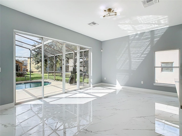 133 Andalusia Loop, Davenport, FL 33837 - unfurnished room featuring baseboards, visible vents, and plenty of natural light