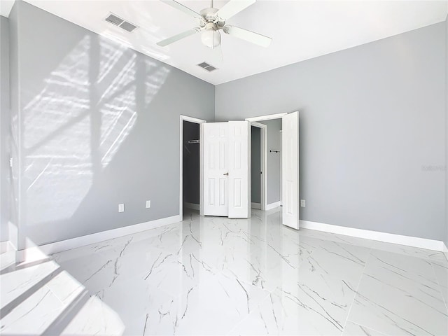 bedroom with a walk in closet, a closet, and ceiling fan