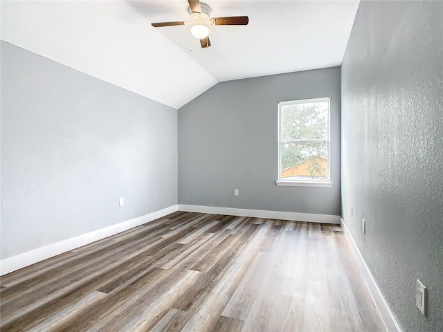 bonus room featuring lofted ceiling, hardwood / wood-style flooring, and ceiling fan