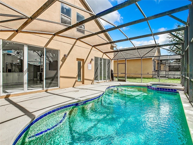 view of swimming pool featuring a patio, an in ground hot tub, and glass enclosure