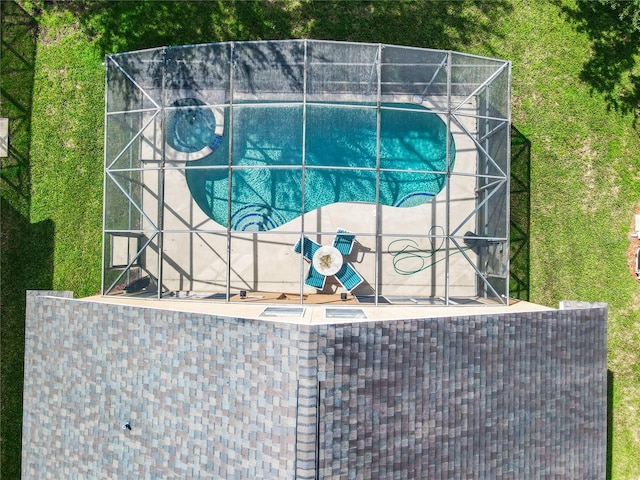 view of swimming pool with a patio area and glass enclosure