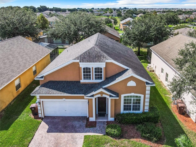 view of front of property featuring a front lawn and a garage