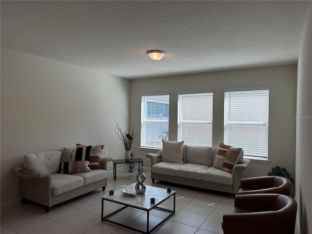 tiled living room featuring a textured ceiling