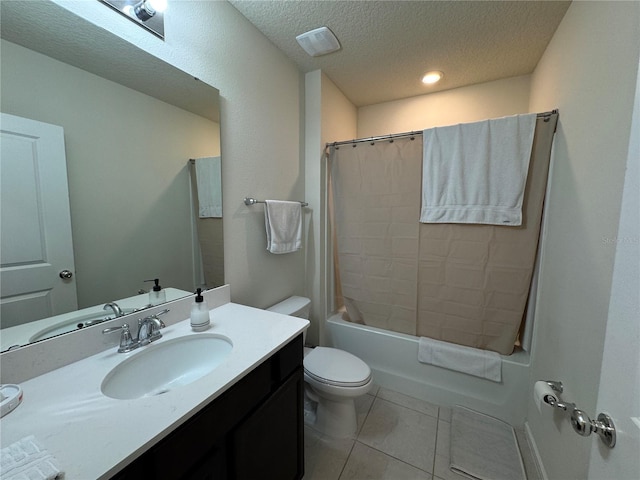 full bathroom featuring vanity, toilet, a textured ceiling, tile patterned flooring, and shower / tub combo with curtain