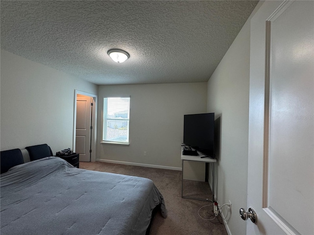 bedroom featuring a textured ceiling and carpet floors