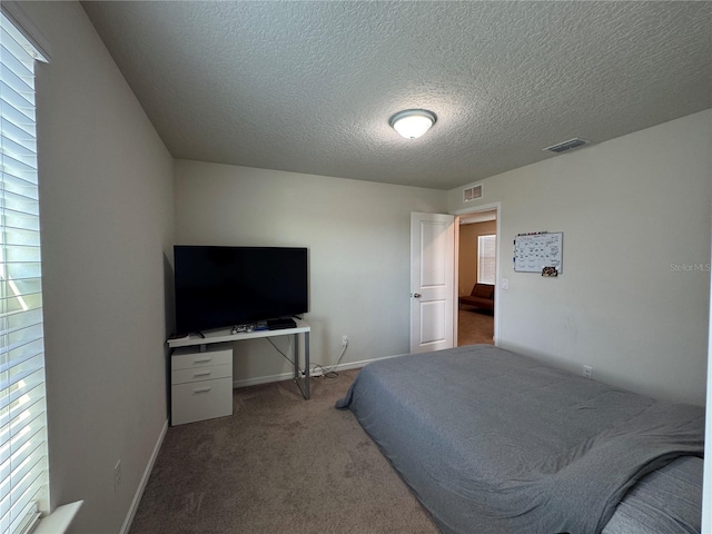 carpeted bedroom with a textured ceiling