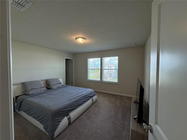 carpeted bedroom with a textured ceiling