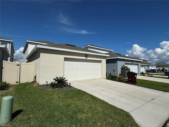 view of side of property featuring a lawn and a garage