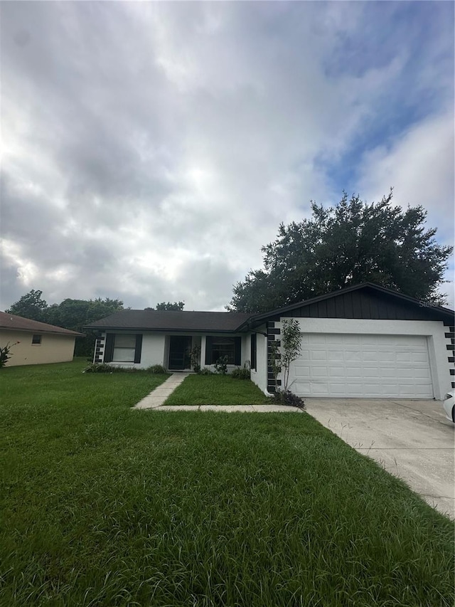 single story home with a front yard and a garage