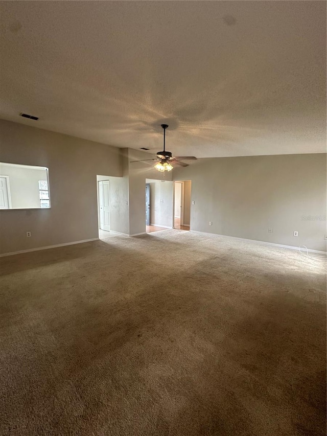 unfurnished room featuring ceiling fan, carpet, and a textured ceiling