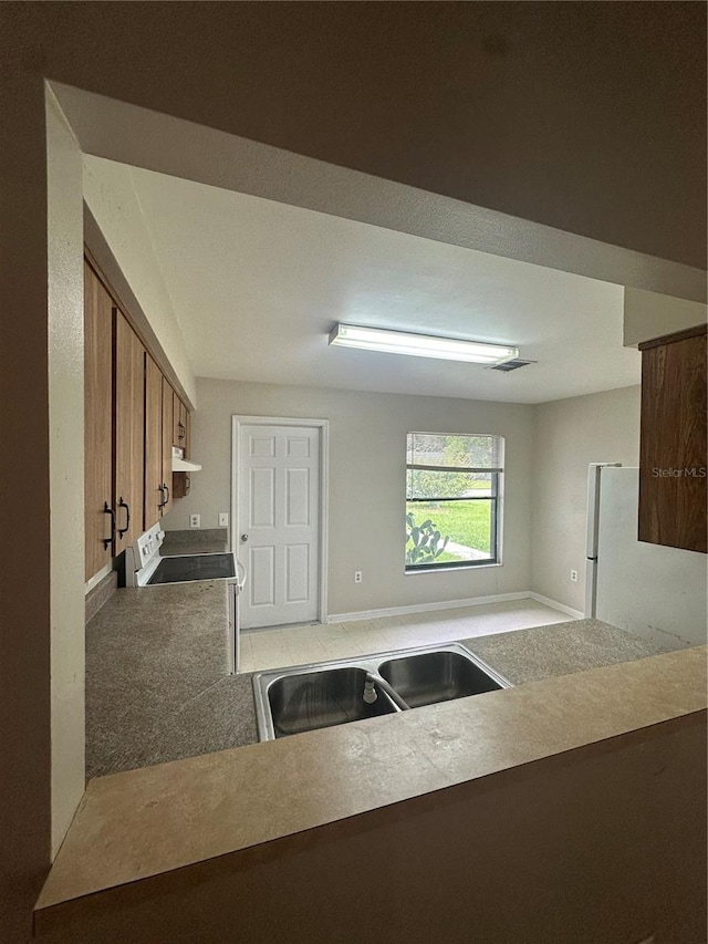 kitchen with stove and carpet flooring