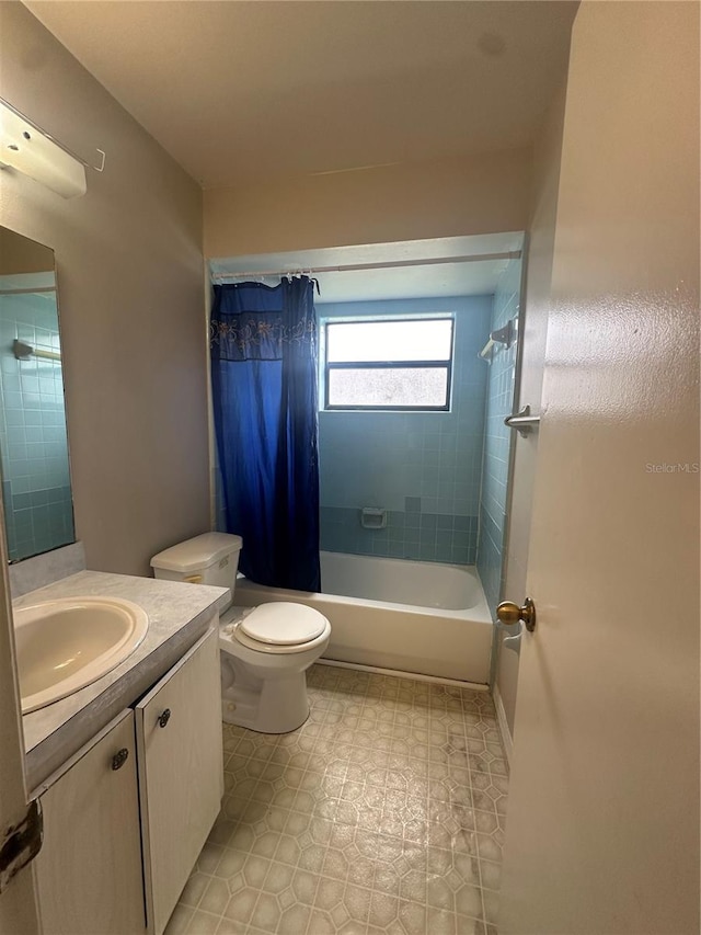 full bathroom featuring toilet, shower / tub combo, and vanity