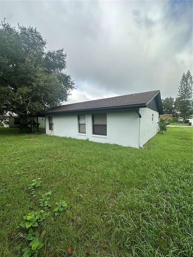 view of property exterior with a lawn