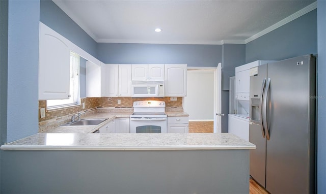 1501 NE 57th St, Ocala, FL 34479 - kitchen featuring white appliances, a sink, white cabinetry, a peninsula, and crown molding
