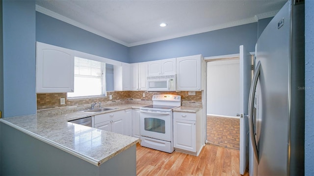 1501 NE 57th St, Ocala, FL 34479 - kitchen featuring a sink, stainless steel appliances, ornamental molding, white cabinetry, and decorative backsplash