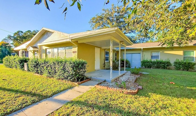 1501 NE 57th St, Ocala, FL 34479 - property entrance with a yard and stucco siding