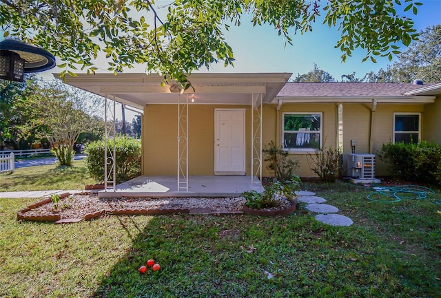 1501 NE 57th St, Ocala, FL 34479 - entrance to property featuring cooling unit, a patio area, fence, and a lawn
