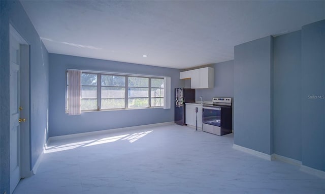 1501 NE 57th St, Ocala, FL 34479 - unfurnished living room featuring washer / dryer, recessed lighting, baseboards, and a sink