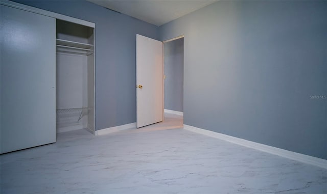 1501 NE 57th St, Ocala, FL 34479 - unfurnished bedroom with concrete flooring, a closet, and baseboards