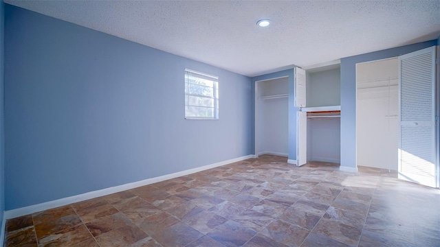1501 NE 57th St, Ocala, FL 34479 - unfurnished bedroom featuring baseboards, stone finish flooring, and a textured ceiling