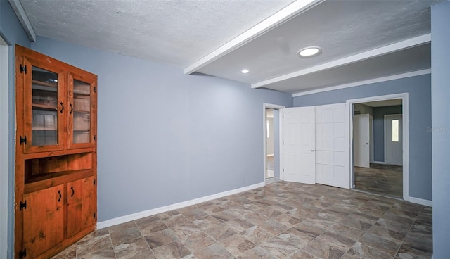 1501 NE 57th St, Ocala, FL 34479 - unfurnished bedroom with baseboards, a textured ceiling, recessed lighting, and stone finish floor