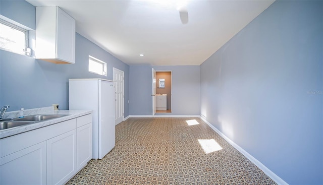 1501 NE 57th St, Ocala, FL 34479 - corridor featuring a sink, light colored carpet, and baseboards