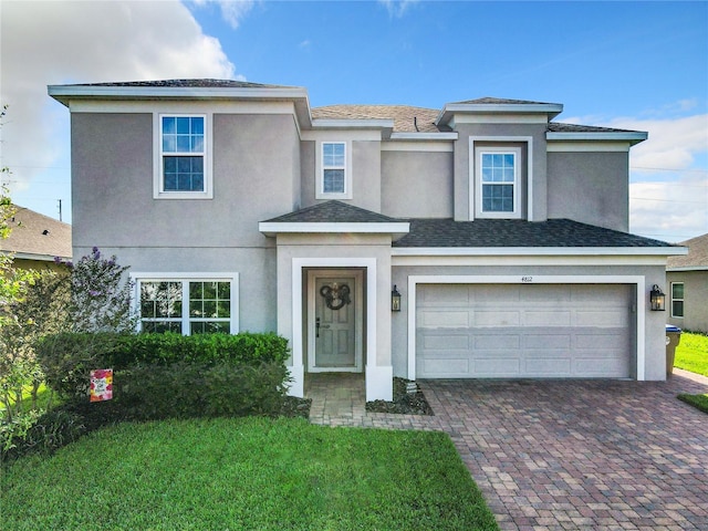 view of front of home featuring a front lawn and a garage