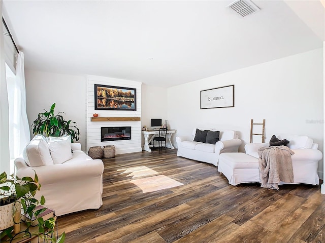 living room with dark hardwood / wood-style floors and a fireplace