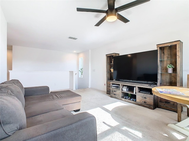 carpeted living room featuring ceiling fan