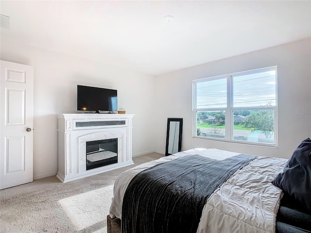 bedroom featuring light colored carpet