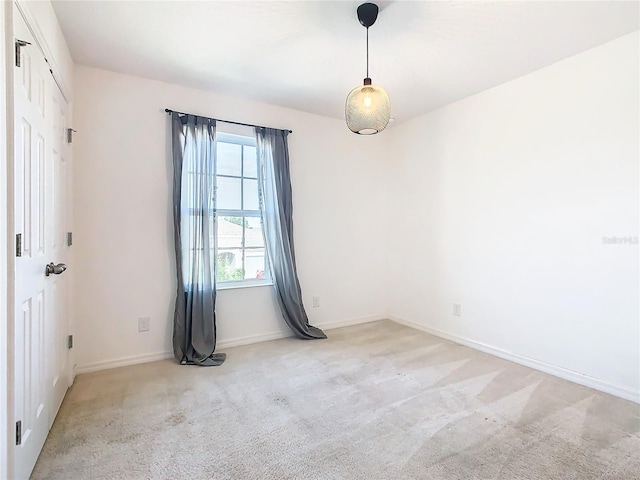 empty room featuring light carpet