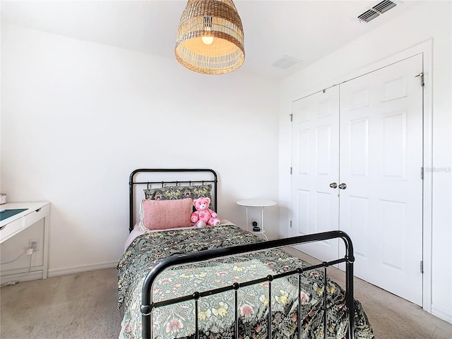 bedroom featuring light colored carpet and a closet