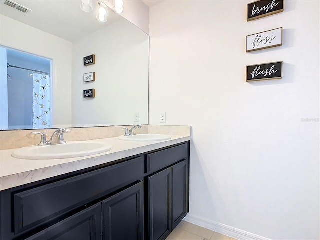 bathroom with tile patterned flooring and vanity