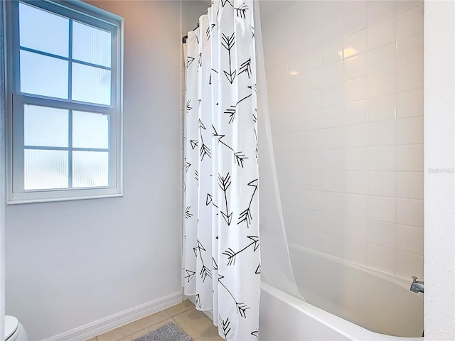 bathroom with shower / tub combo, toilet, and tile patterned floors