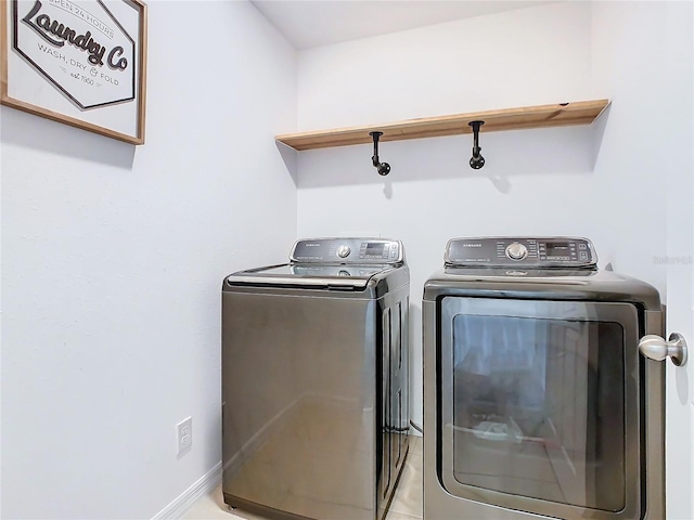 clothes washing area with washing machine and dryer