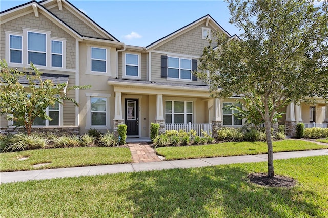 craftsman-style house with a front lawn