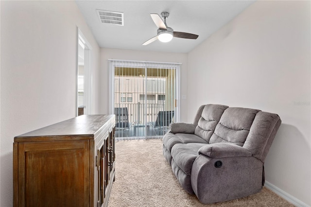 carpeted living room featuring ceiling fan