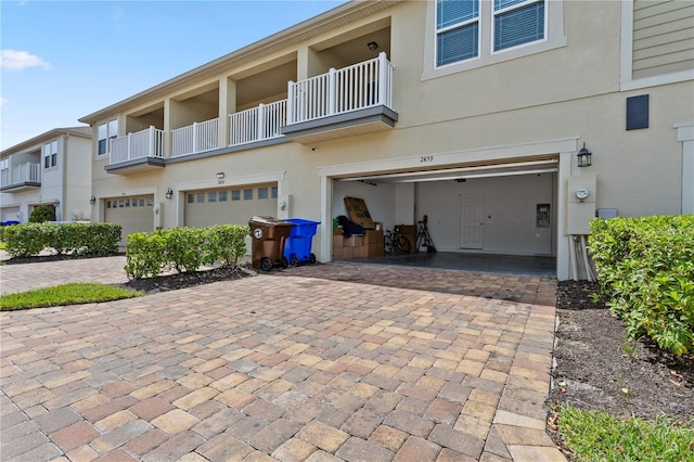 exterior space featuring a balcony and a garage